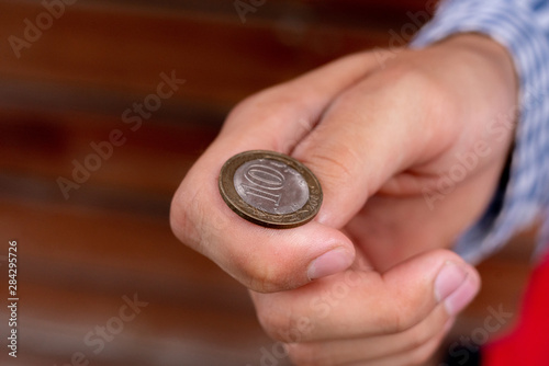 close up shot of hand toss a coin, probable and winning chances concept, fifty-fifty