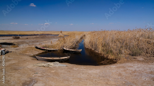 runed Urga fishing village at the shore of Sudochye lake aka part of former Aral sea, Karakalpakstan, Uzbekistan photo