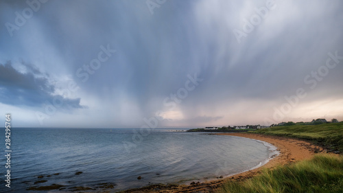 Thundery skies over Brora beach in Sutherland in the Highlands of Scotland