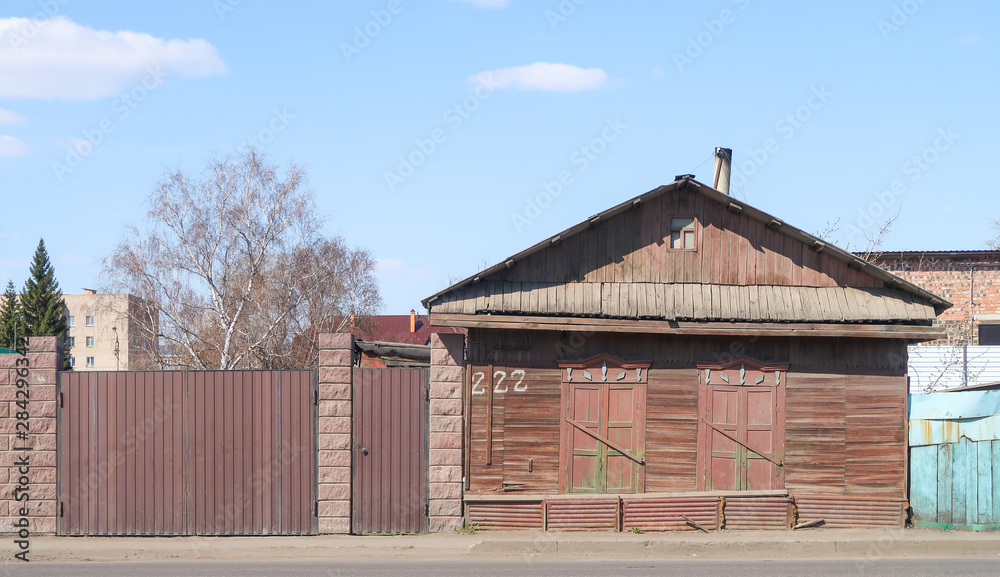Petropavlovsk, Kazakhstan - May 2, 2019: House with a fence against the blue sky, spring landscape.