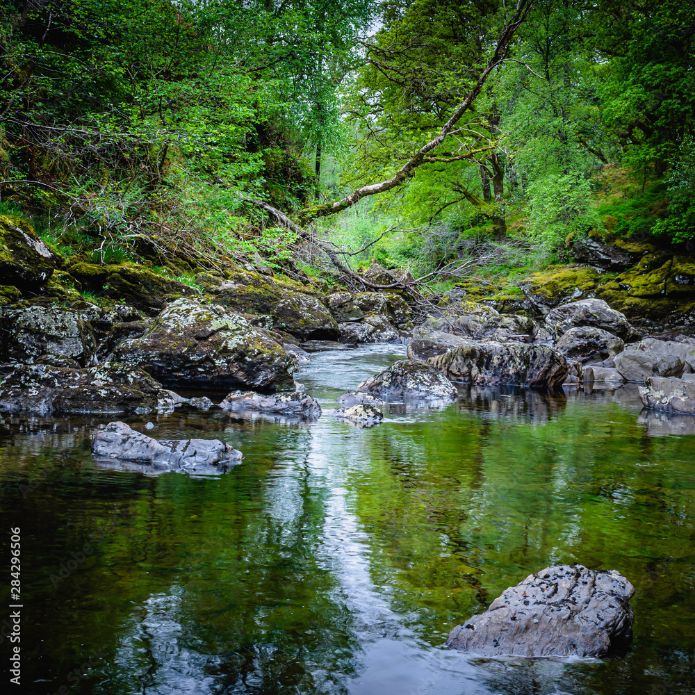 Beautiful landscape of Scotland ,UK.Stream with rocks in forest. Beautiful landscape of Scotland ,UK.Stream with rocks in forest.
