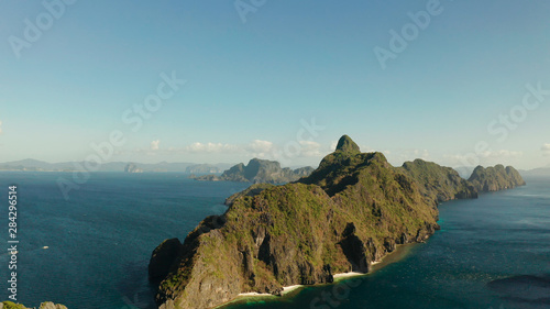Seascape with tropical rocky islands, ocean blue water, aerial view . islands and mountains covered with tropical forest. El nido, Philippines, Palawan. Tropical Mountain Range © Alex Traveler