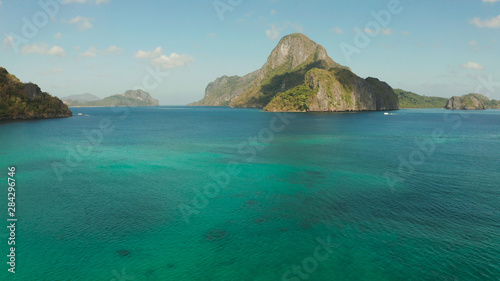 Seascape with tropical bay, rocky islands, ocean blue water, aerial view. islands and mountains covered with tropical forest. El nido, Philippines, Palawan. Tropical Mountain Range © Alex Traveler