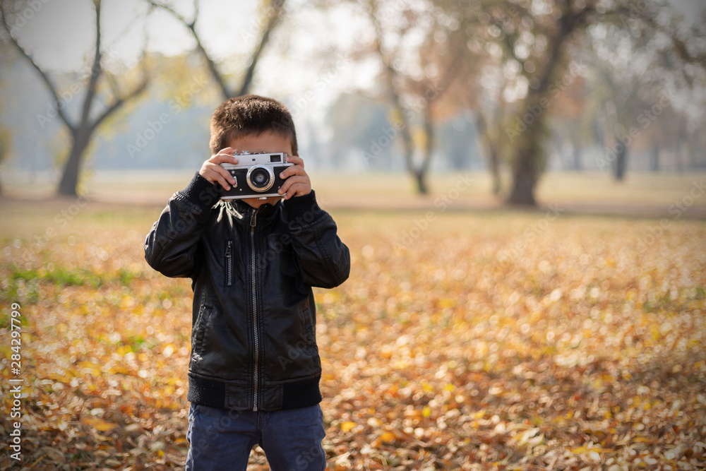Little Boy With Retro Camera In Autumn Park Little Boy With Retro Camera In Autumn Park