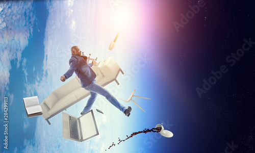 Businessman jumping in gravity. Mixed media
