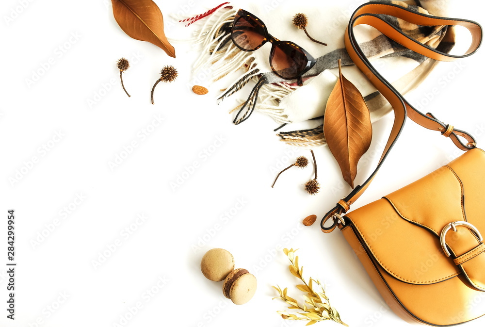 Autumn composition with women fashion  accessories top view on white background toned. Flat lay collage of female style look with bag, sunglasses, scarf, notebook mock up, autumn leaves. Copy space - obrazy, fototapety, plakaty 