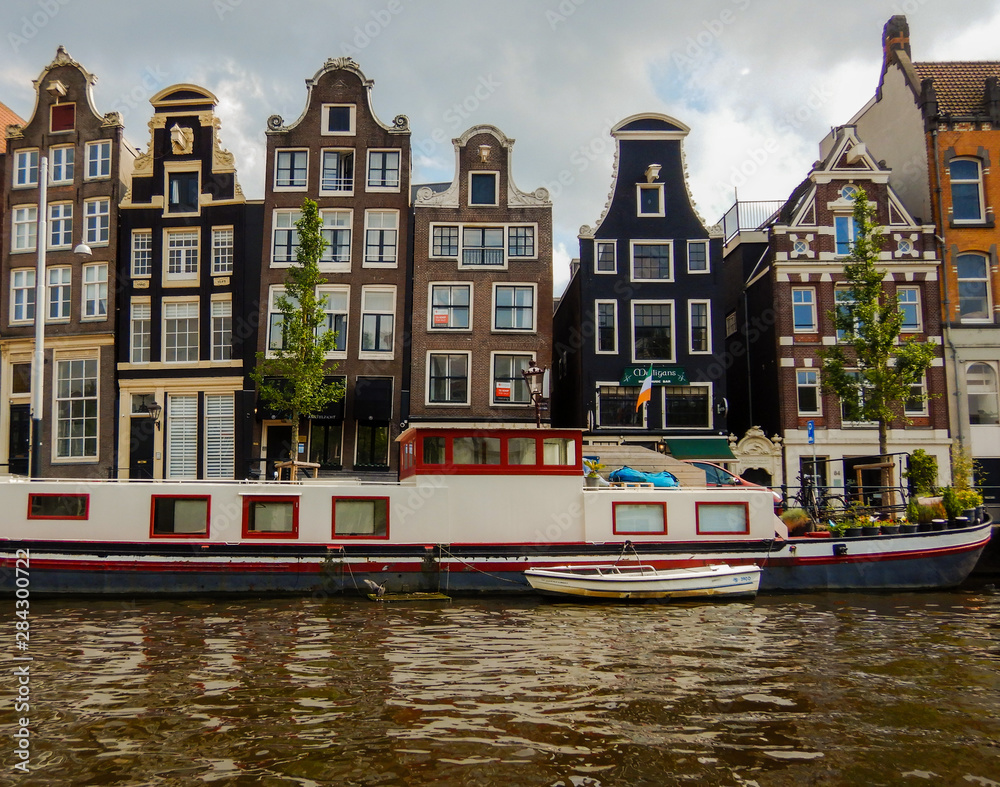 Sloping houses and boat on the canals in Amsterdam