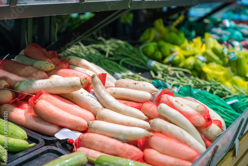 Fresh tropical vegetable on shelves in modern supermarket