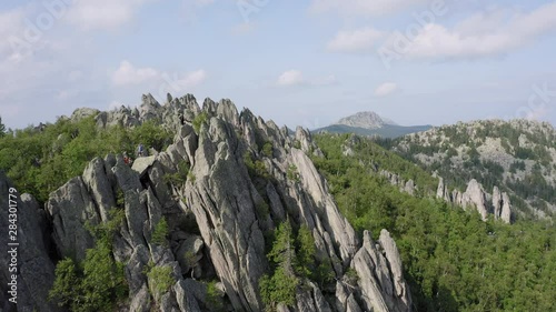 aerial view of ural nature. drone flying over the steep stony slope with coniferous and deciduous mixed forest at the foot of mountain. natiounal park, ecological protected area in Russia