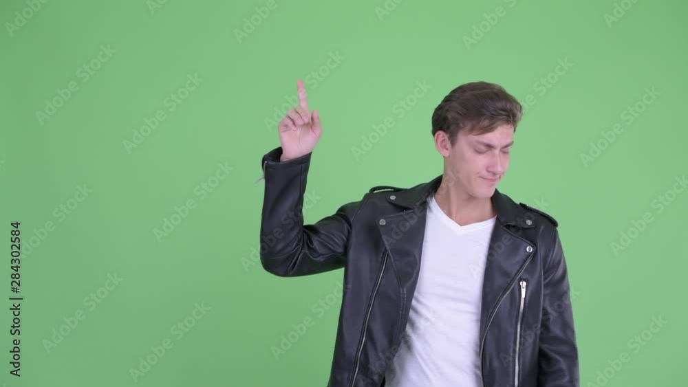 Stressed young rebellious man thinking while pointing up Stressed young rebellious man thinking while pointing up