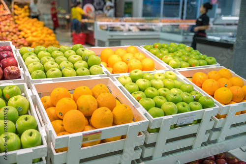 Fresh healthy fruits on shelves in supermarket
