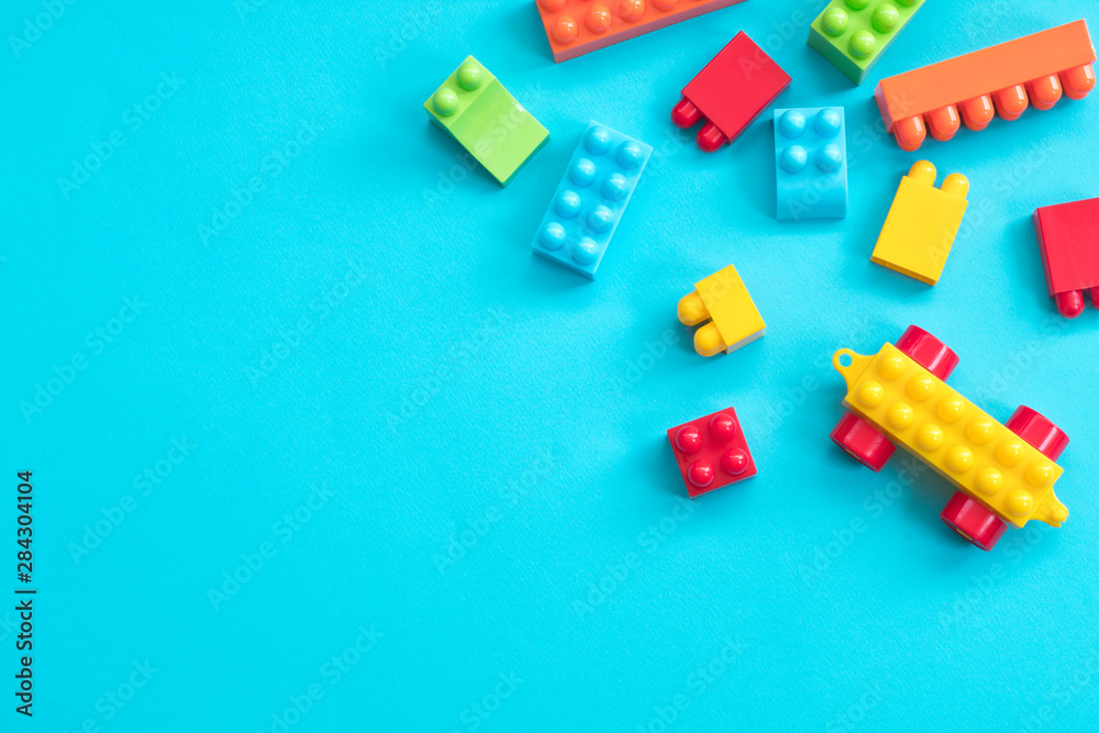 Plastic toy blocks on blue background Plastic toy blocks on blue background