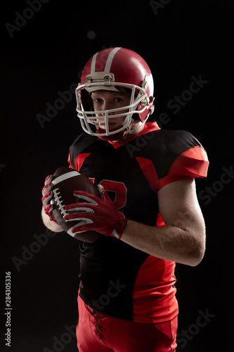 American football player in helmet holding rugby ball © wavebreak3