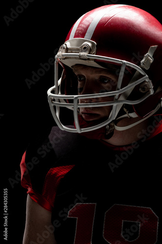 American football player standing with rugby helmet © wavebreak3