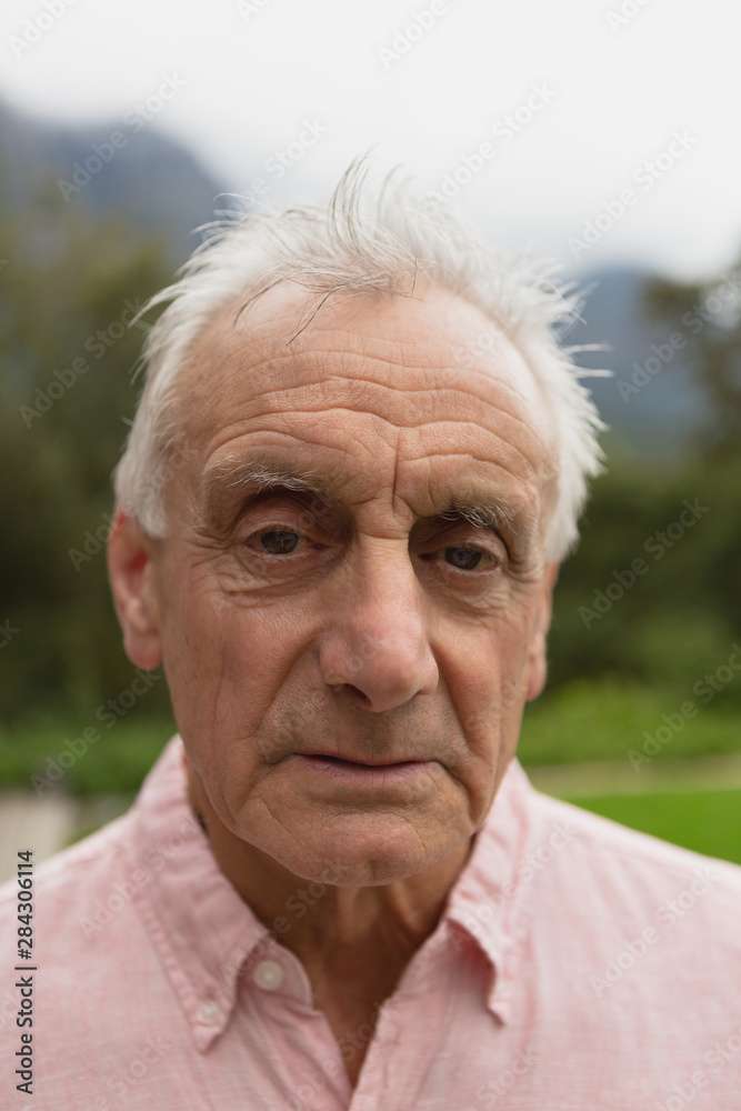 Active senior man standing in the backyard Active senior man standing in the backyard