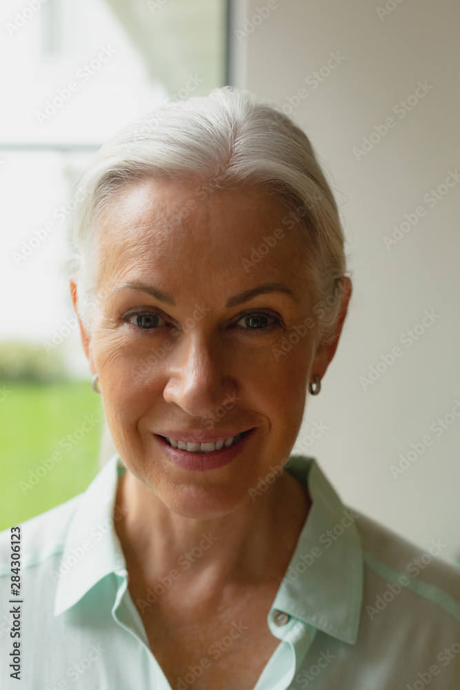 Active senior woman standing in the porch at home Active senior woman standing in the porch at home