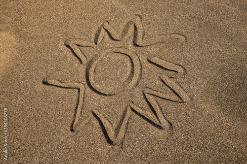 sun drawed on the sand