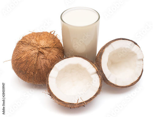 Coconut milk with fresh whole nut and half isolated on a white background. Creative cosmetic concept. Top view, flat lay