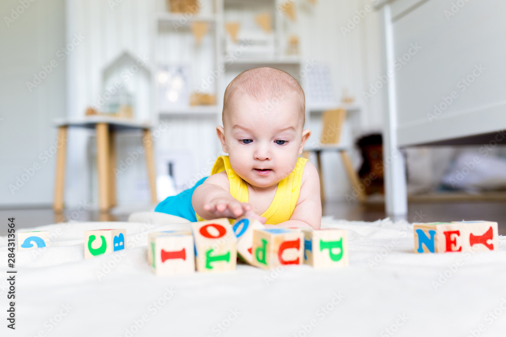 Early development of the child with educational toys. Kid playing wooden blocks. Children education.