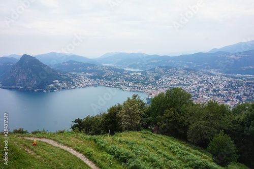 Panorama of the lake and the city of Lugano from the observation deck on Mount Monte Bre