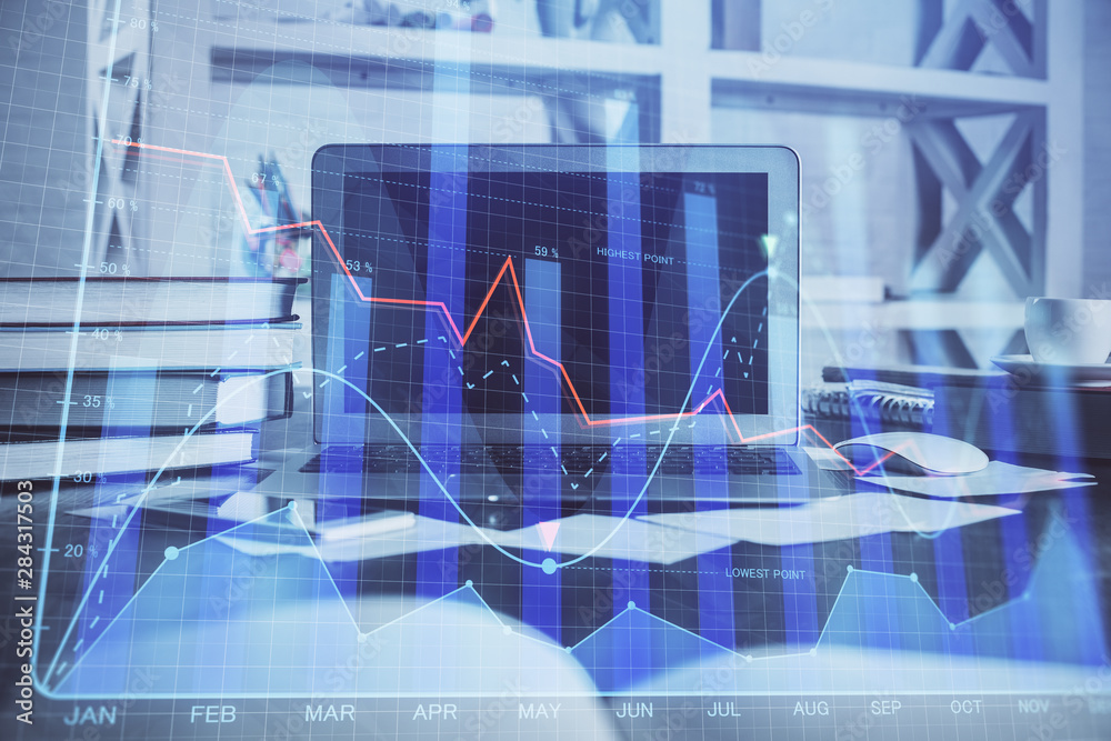 Financial chart drawing and table with computer on background. Double exposure. Concept of international markets. Financial chart drawing and table with computer on background. Double exposure. Concept of international markets.