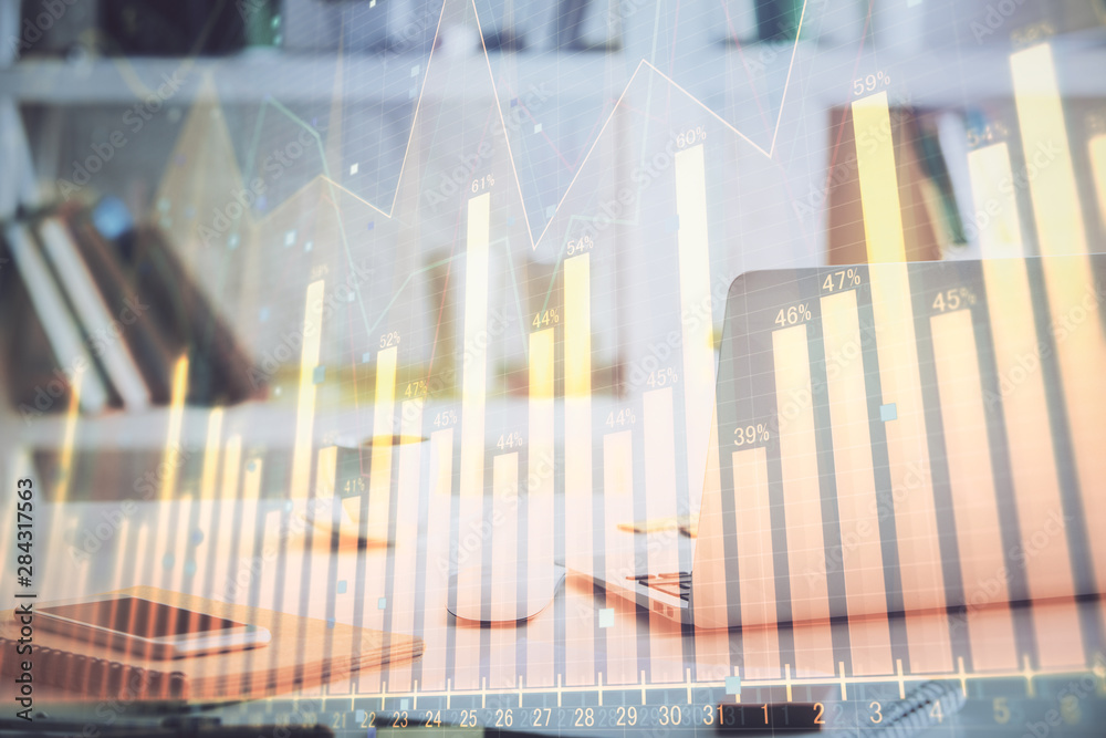 Stock market graph and table with computer background. Double exposure. Concept of financial analysis.