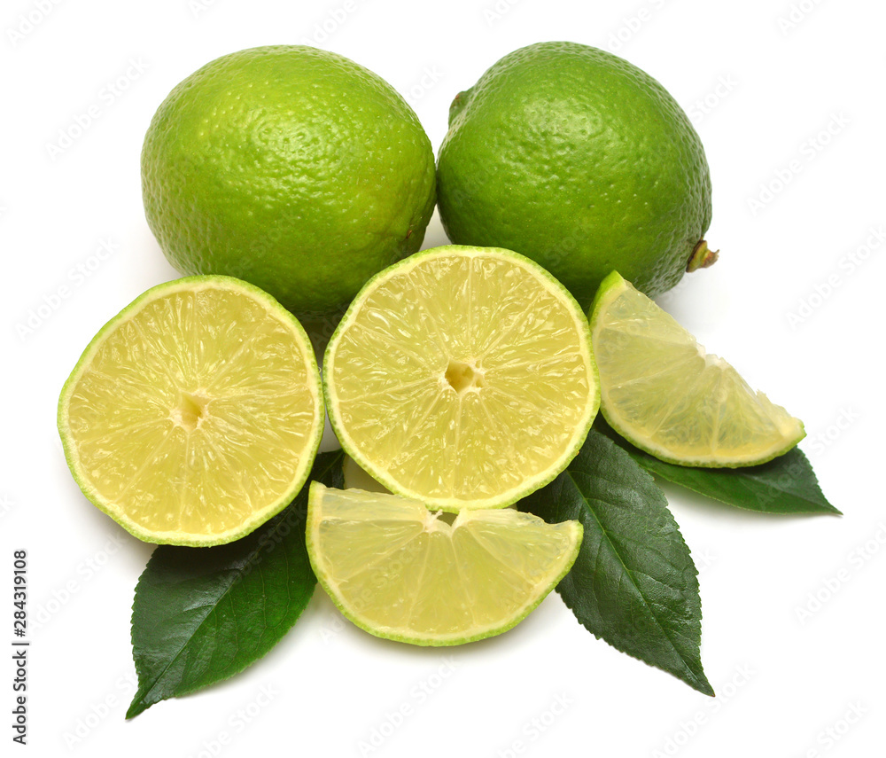 Lime fruit whole, half and slices with leaf isolated on a white background. Creative juice concept. Flat lay, top view Lime fruit whole, half and slices with leaf isolated on a white background. Creative juice concept. Flat lay, top view