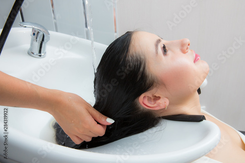 young beautiful woman wash their hair in a beauty salon