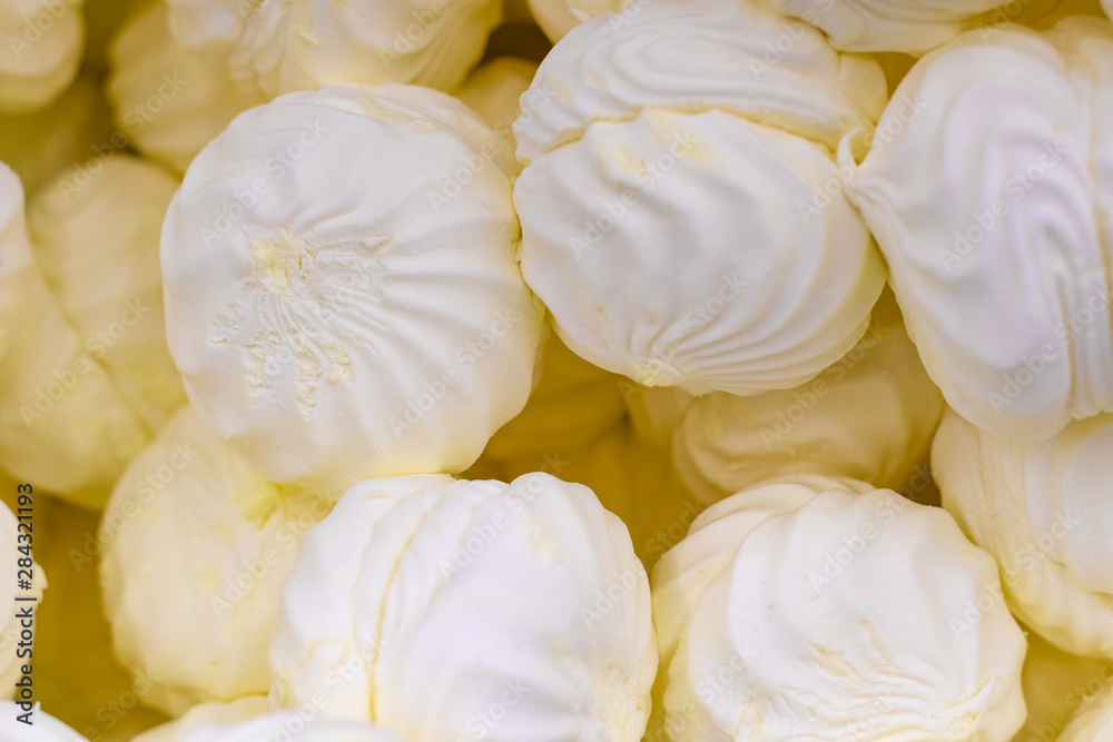 Bunch of lemon yellow delicious marshmallows closeup, selective focus.