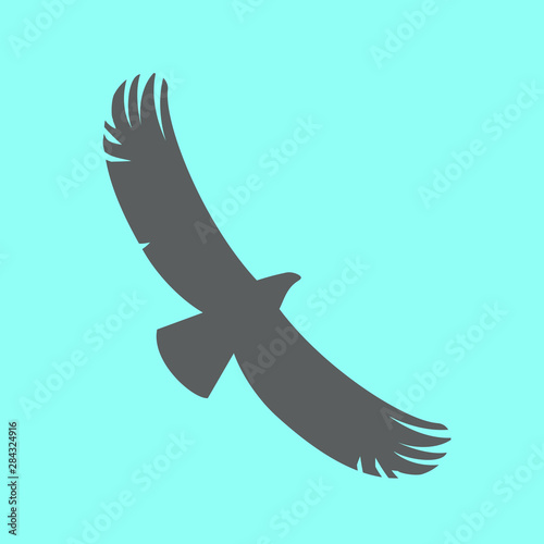 Brown silhouette of a soaring eagle in the blue sky. Vector illustration.
