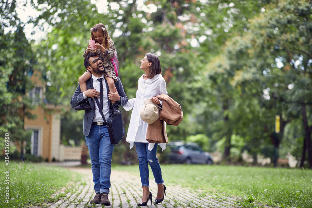 family walking home after first day of school family walking home after first day of school