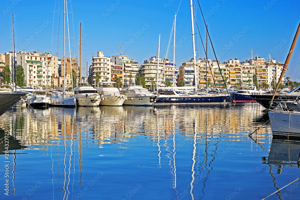 sailboats and yachts reflected on sea at Pasalimani harbor Piraeus Greece