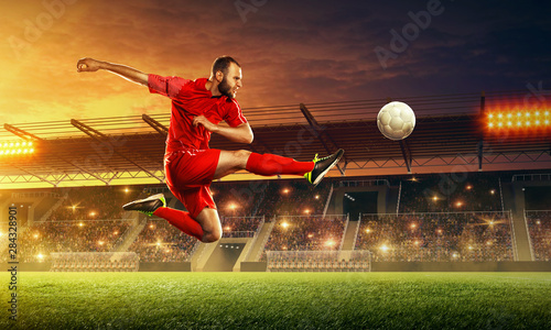 Soccer player in action on a stadium. Kicking the ball. Soccer game. Sports championship. Soccer field.
