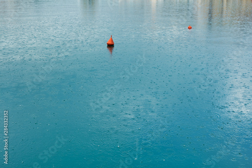 Raindrops on the water surface in the harbor