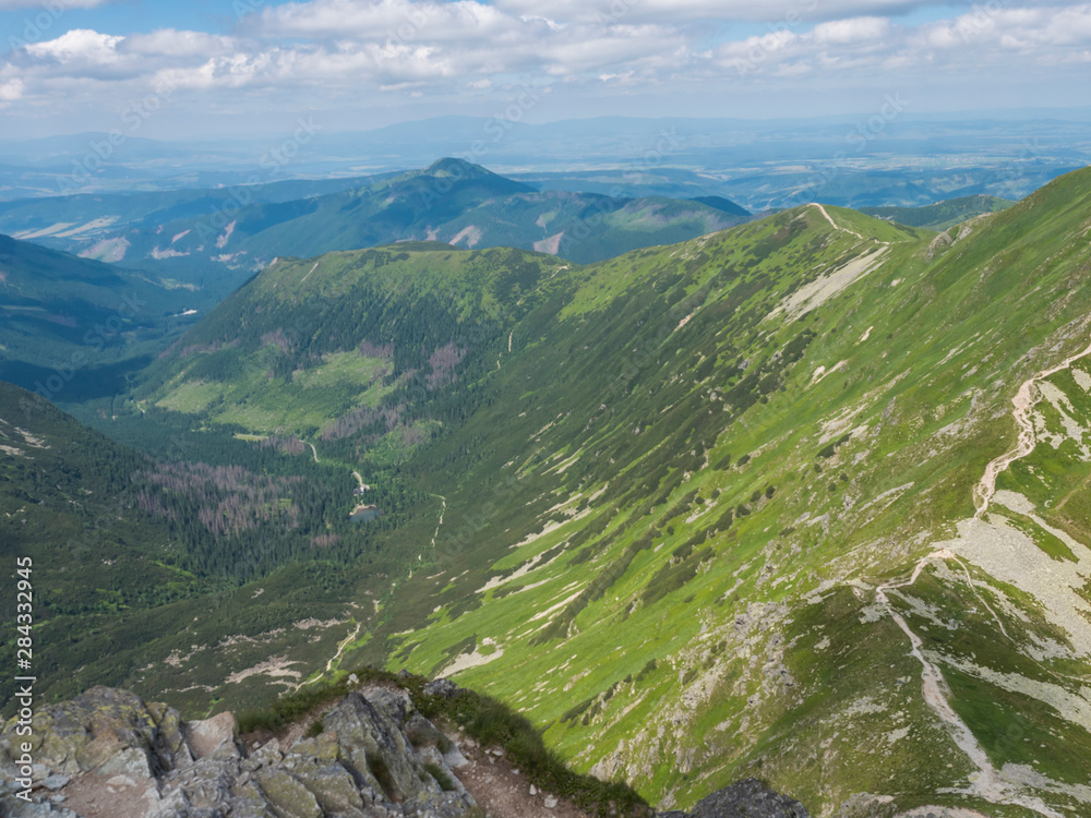 View from the Smutne sedlo saddle on Smutna dolina valley with Beautiful blue mountain lake Tatialkovo jezero with green mountain peaks , Western Tatras mountains, Rohace Slovakia, summer sunny day