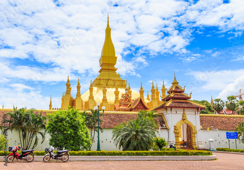 Vientiane Lao-July 6 2019   Pha That Luang with blue sky background  Historical ancient golden pagoda religion place  view at front gate  editorial image 