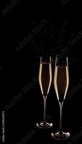 Two glasses of champagne isolated on black background