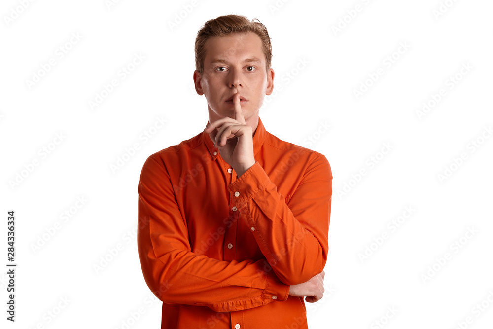 Close-up portrait of a ginger guy in orange shirt posing isolated on white background. Sincere emotions. Close-up portrait of a ginger guy in orange shirt posing isolated on white background. Sincere emotions.