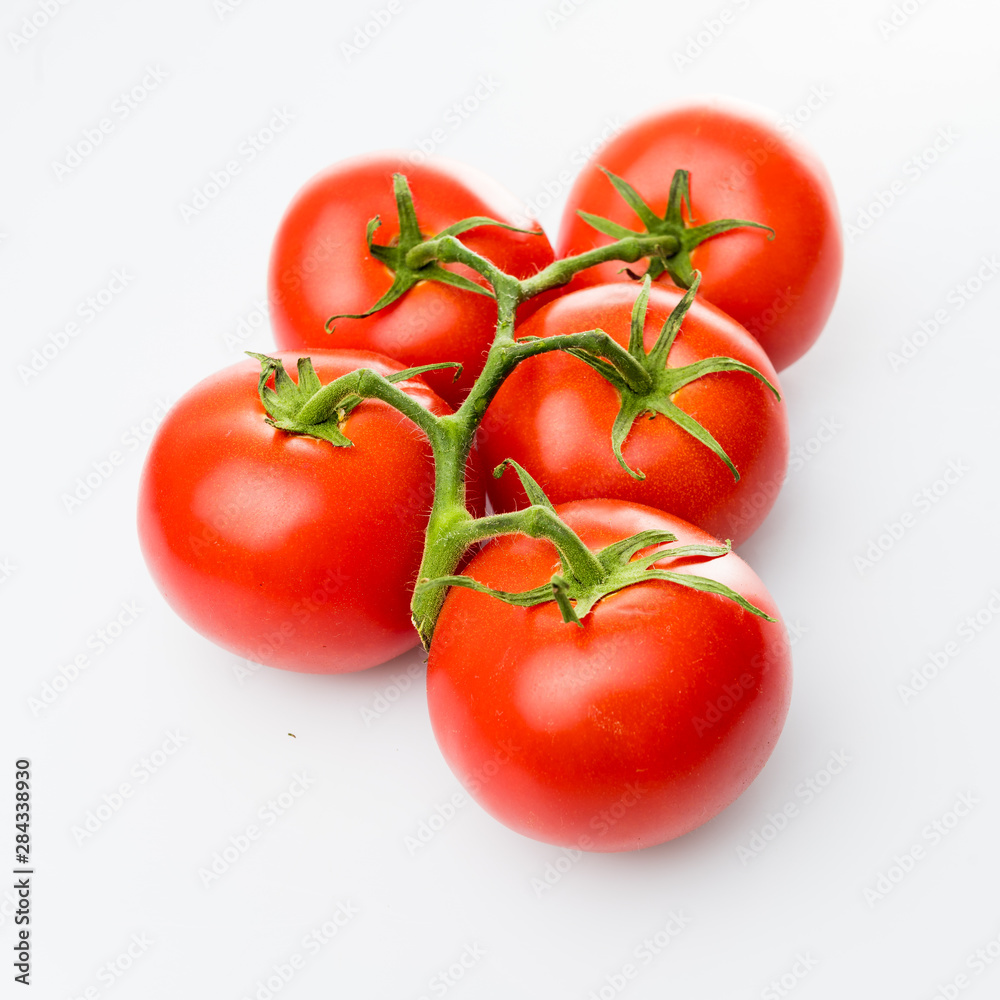 Tomato branch. Tomatoes isolated on white Tomato branch. Tomatoes isolated on white