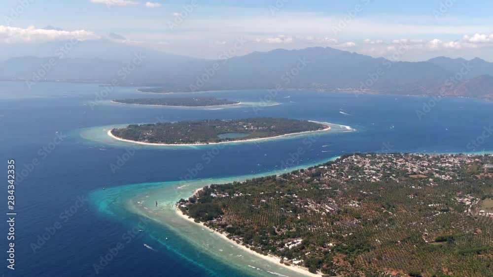 Aerial view of the Gili Islands off the coast of Lombok, Indonesia. The Gilis are a popular holiday destination for tourists visiting Bali and Lombok. Aerial view of the Gili Islands off the coast of Lombok, Indonesia. The Gilis are a popular holiday destination for tourists visiting Bali and Lombok.