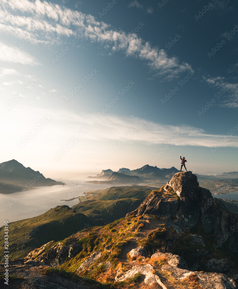 person on the summit of the mountain. Lofoten Islands. perfect golden hour