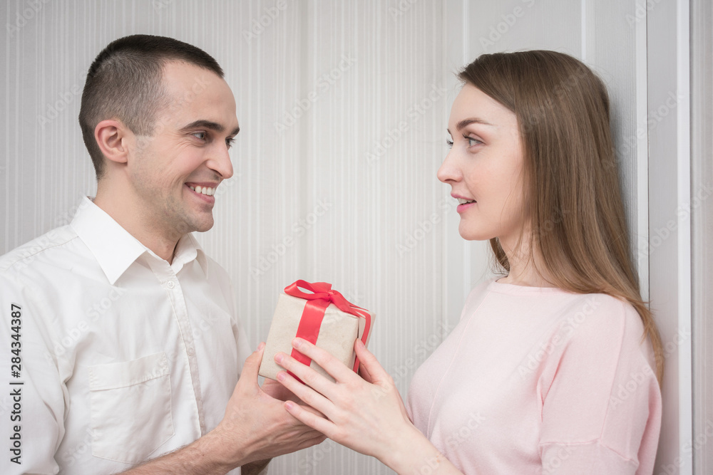 Attractive woman gets a gift from her boyfriend, close up Attractive woman gets a gift from her boyfriend, close up
