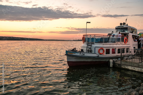 Tourist boat on the lake in Ternopil at sunset, Ukraine. August 2019
