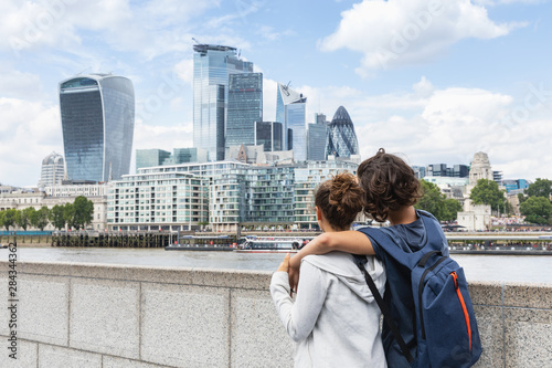 Photography Two guys hold each other while watching the London skyline on a summer day