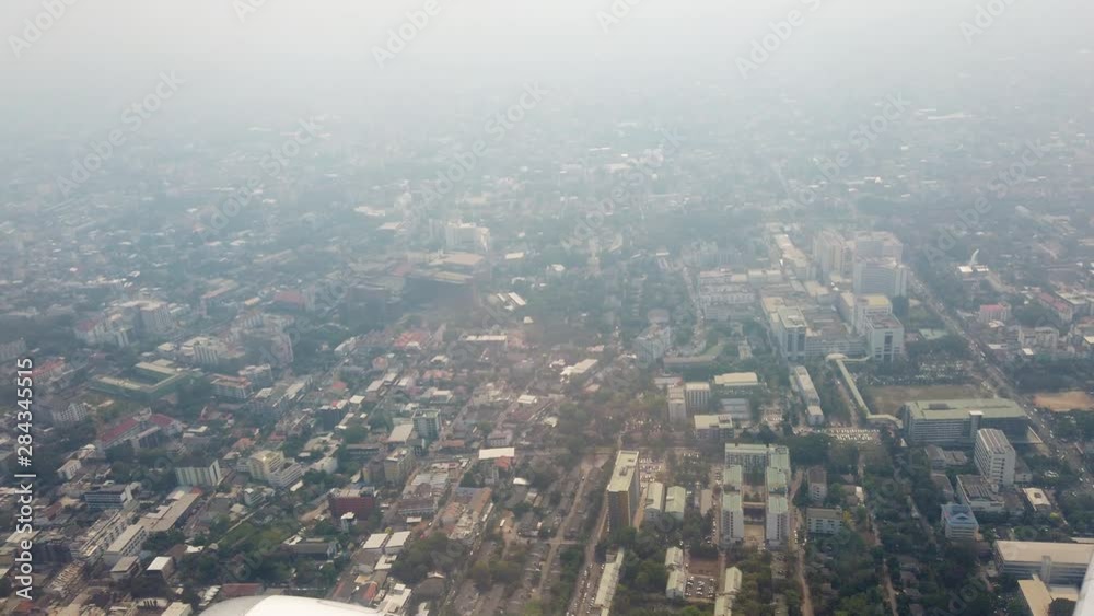4K Aerial Point of view from airplane window of plane taking off airport and flying over city in foggy morning sky. Aircraft wing flying high above the clouds and city. 4K Aerial Point of view from airplane window of plane taking off airport and flying over city in foggy morning sky. Aircraft wing flying high above the clouds and city.