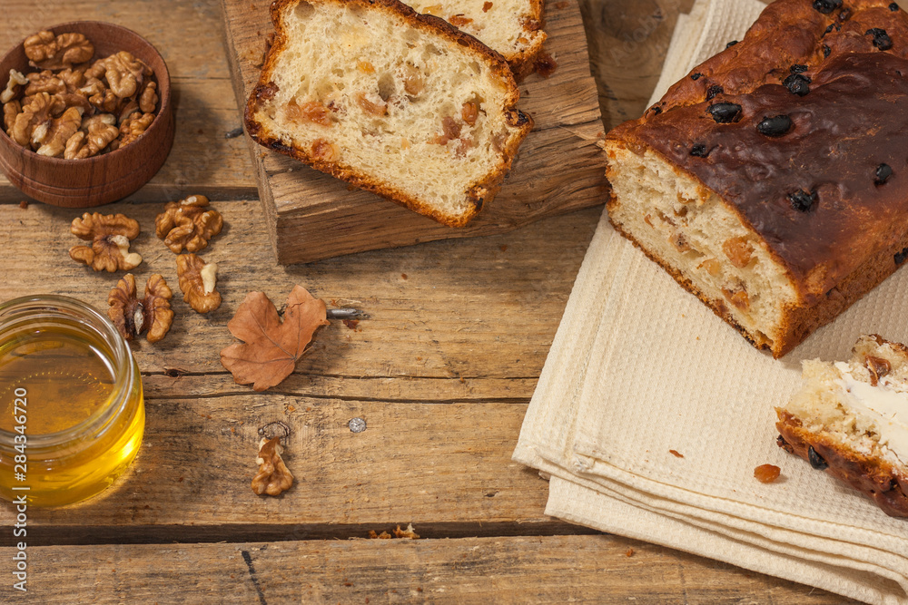 Fototapeta premium Barmbrack or bairin breac is a traditional Irish sweet yeast bread with grapes and raisins, often eaten with afternoon tea butter and traditionally served on Halloween.
