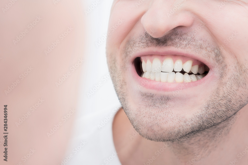Reflection of a man in the mirror, baring his teeth, close up, teeth, looks in the mirror, closeup Reflection of a man in the mirror, baring his teeth, close up, teeth, looks in the mirror, closeup