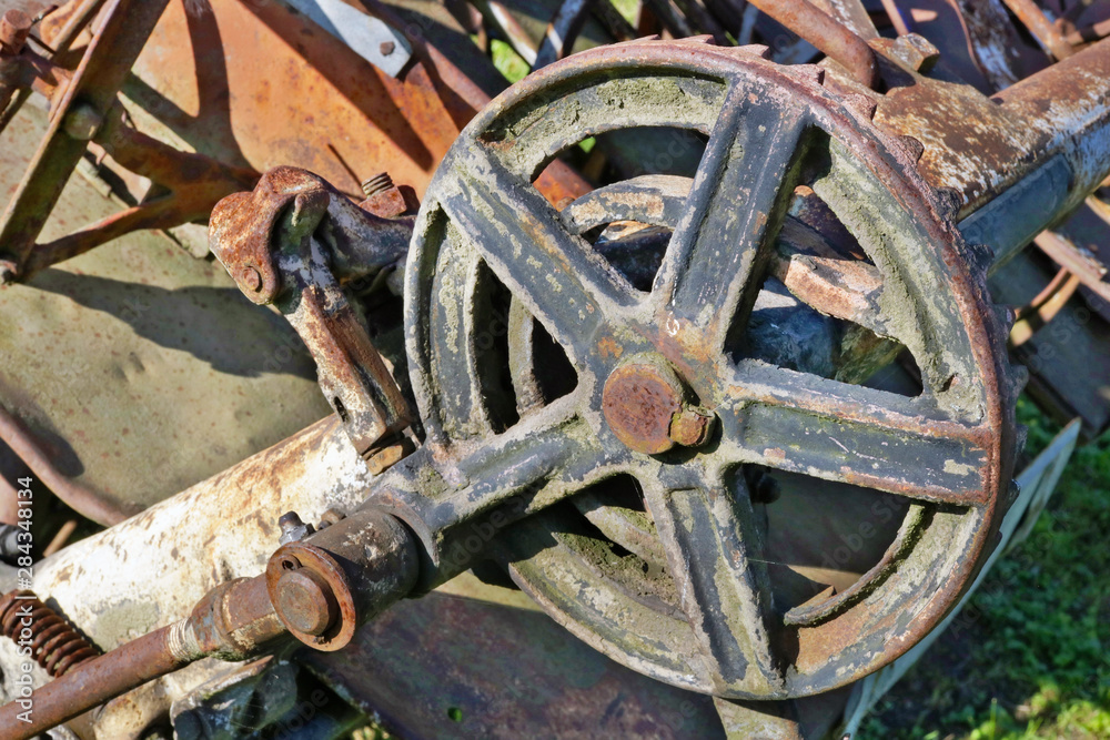 Rusty  retro vintage  small  tractor  gears and wheels background