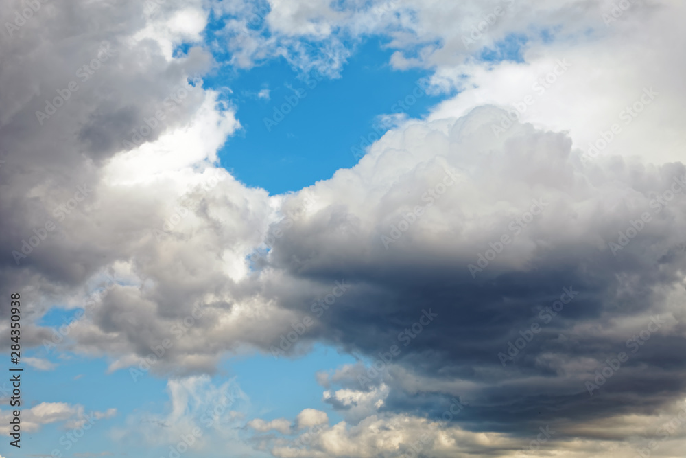 Summer dramatic clouds fly across a bright blue sky. Summer dramatic clouds fly across a bright blue sky.