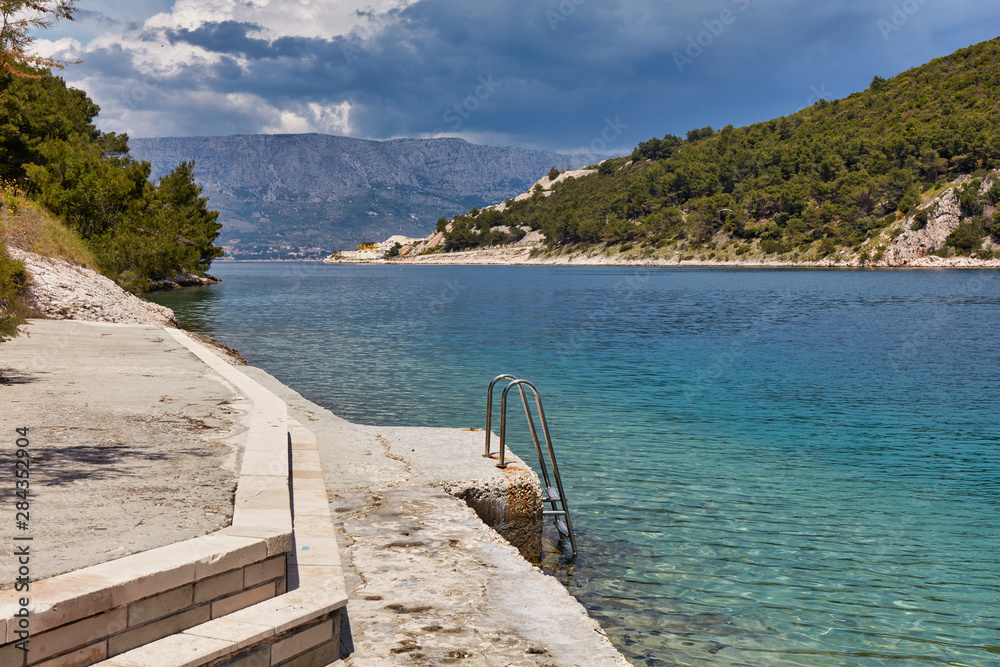 A little, stone public beach, Puscisca, Croatia